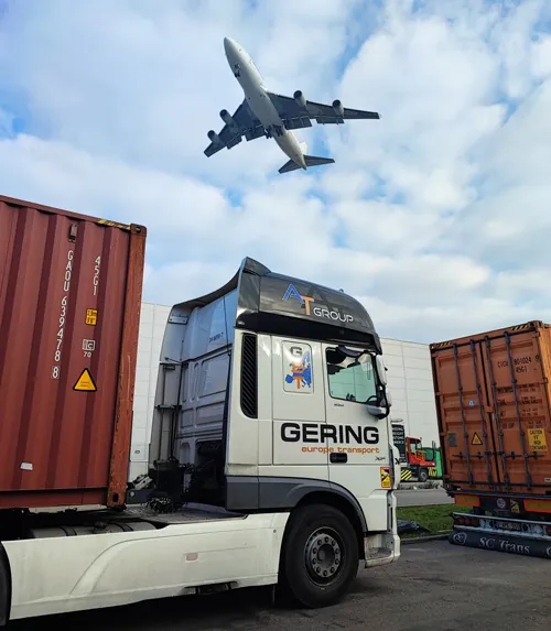 Our truck collecting a container as a cargo plane flies over